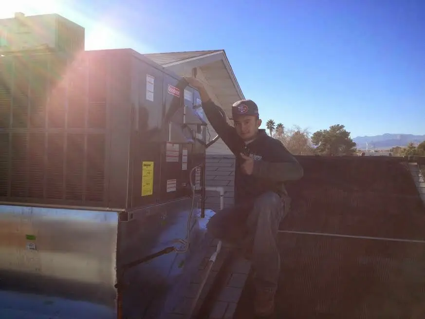 HVAC technician performing HVAC Inspection on a rooftop unit in Newport News